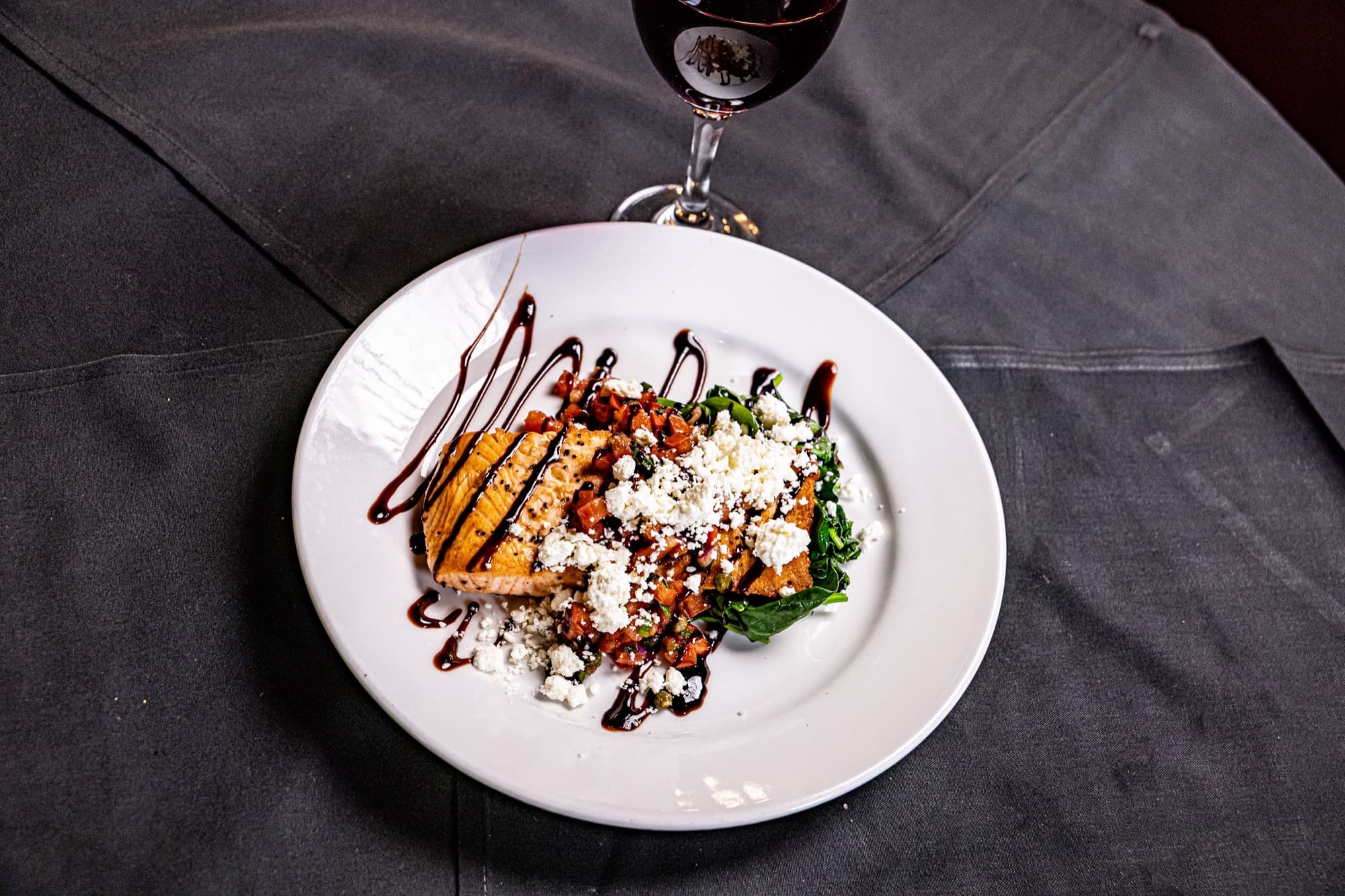 An elegantly plated dessert with balsamic drizzle