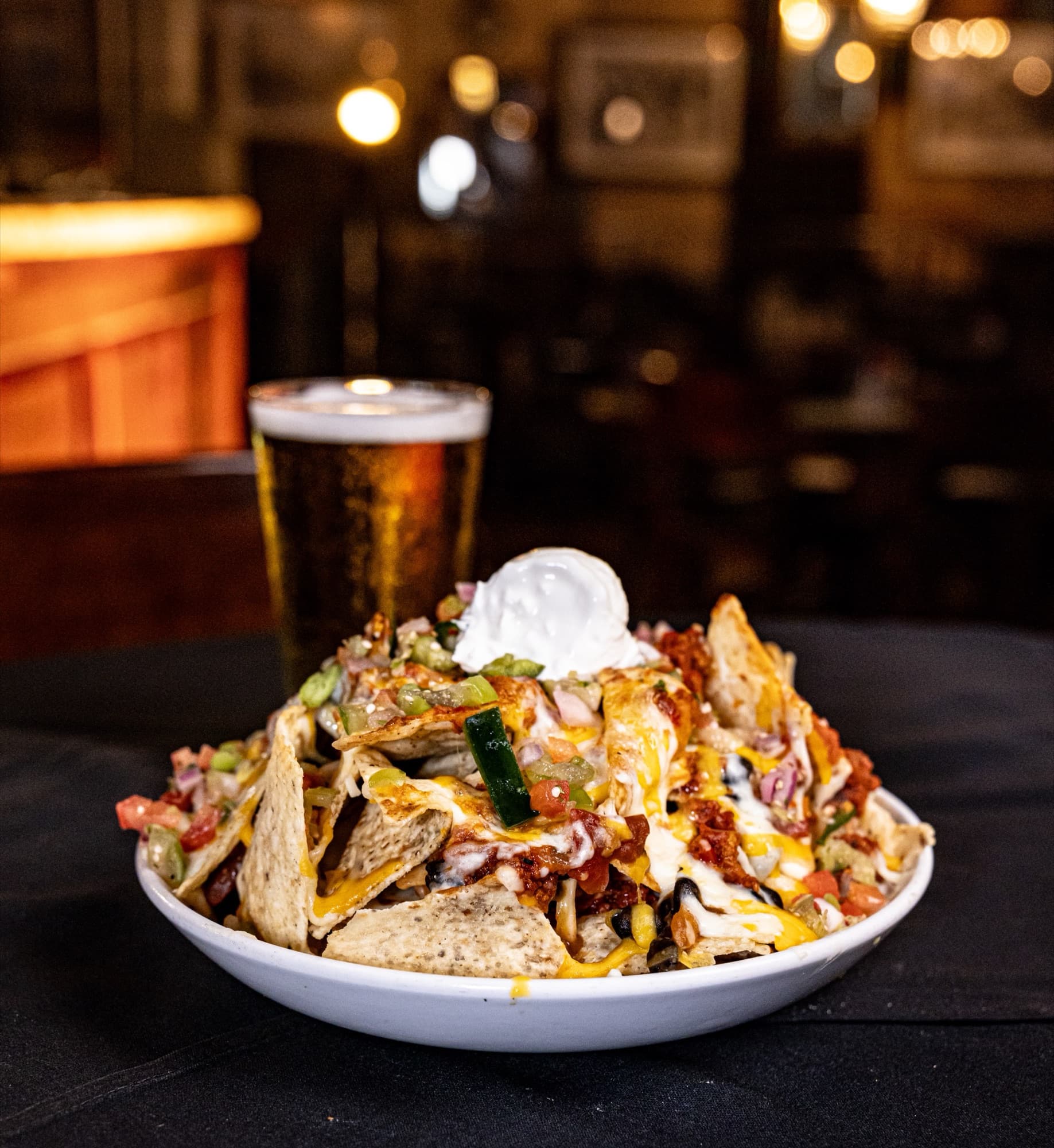 Loaded nachos under warm light