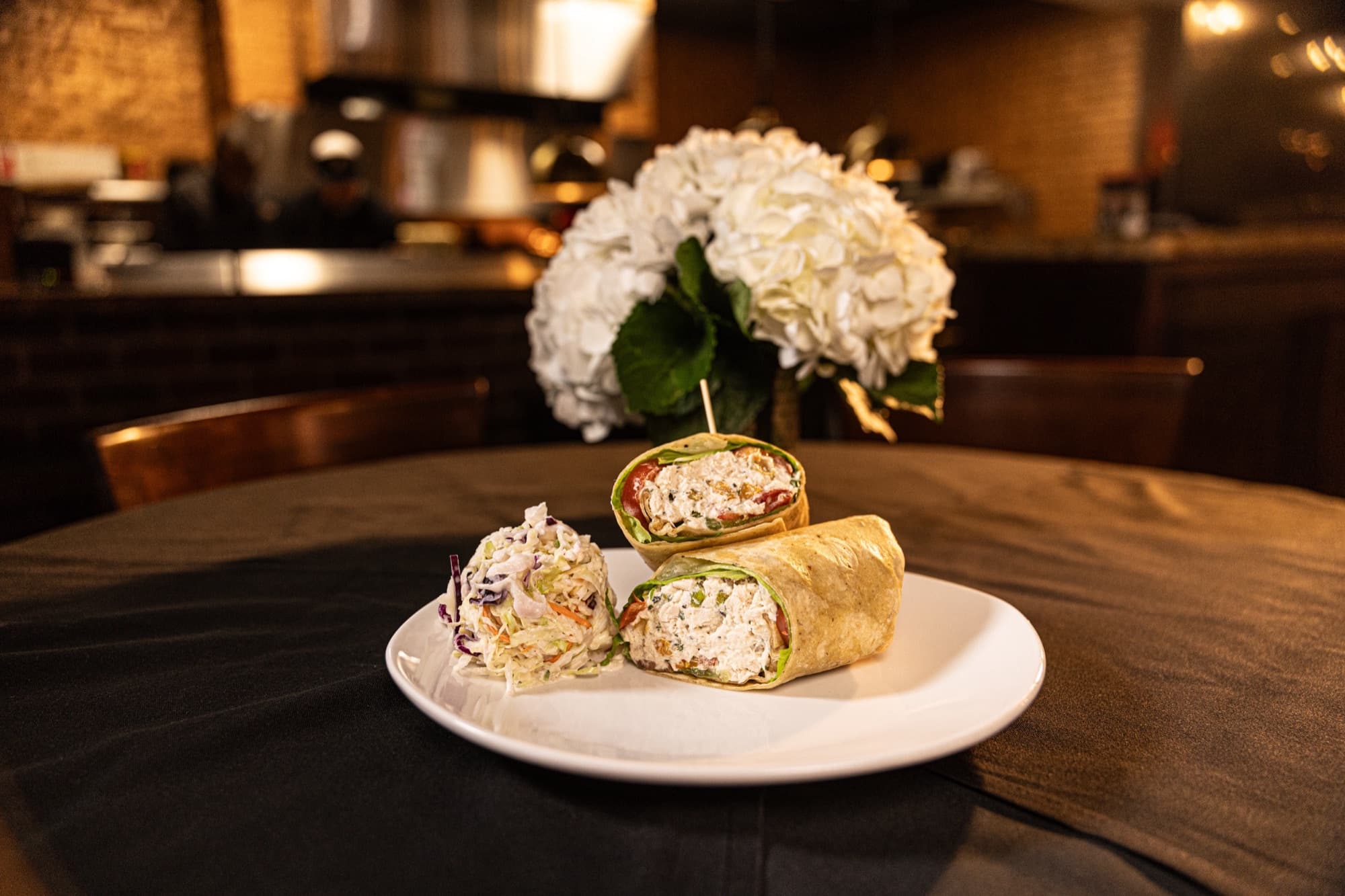 Chicken salad wrap pinwheels plated with flowers